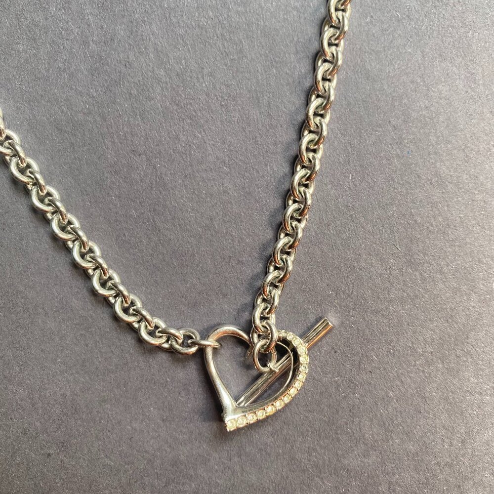 Silver tone jewelry necklace with a heart pendant